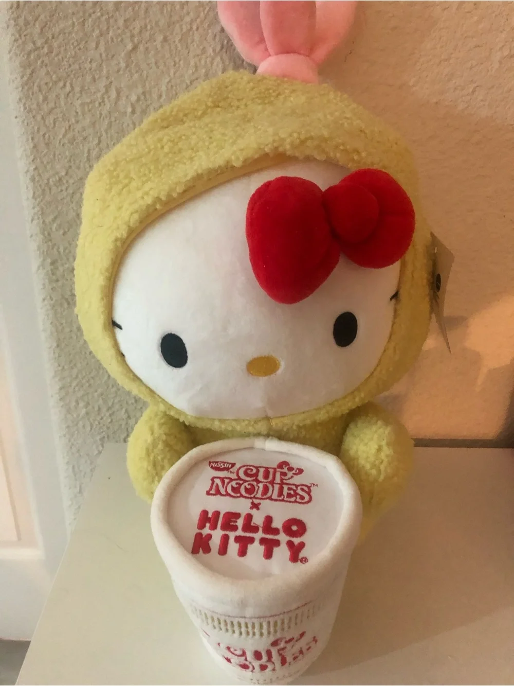 Hello Kitty Plush in Yellow Costume with Red Bow and White Cup Noodles Accessory